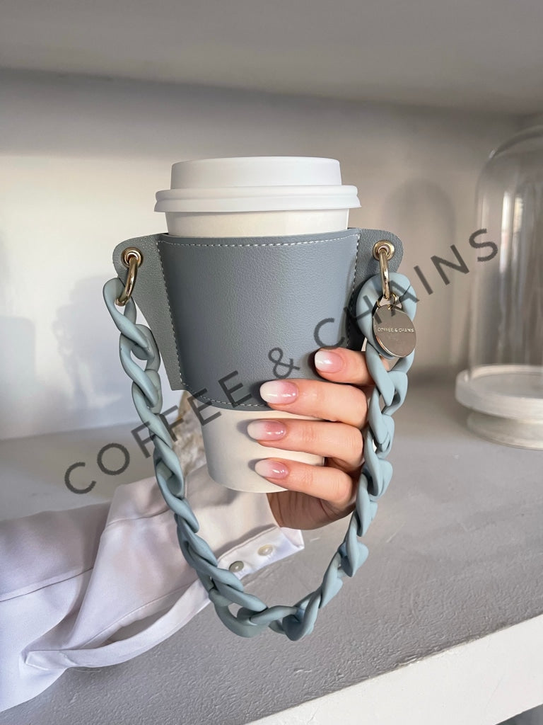 https://coffeeandchains.com/cdn/shop/products/santorini-blue-coffee-sleeve-442.jpg?v=1647196700